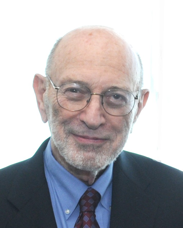 Portrait of Stanley N. Cohen in a dark suit and glasses